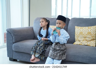 Two Siblings Wearing Malay Traditional Clothes. Hari Raya Aidilfitri Celebration Concept.