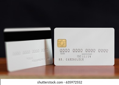 Two sides of blank white credit card with embossing