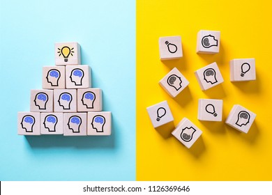 two sides symbolizing with icons on cubes a structured organization with innovation and a chaotic organization showing no progress