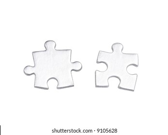 Two Silver Matching Puzzle Pieces Over White Background