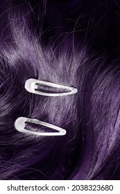 Two Simple Clip Barrettes On Dark Purple Hair Closeup