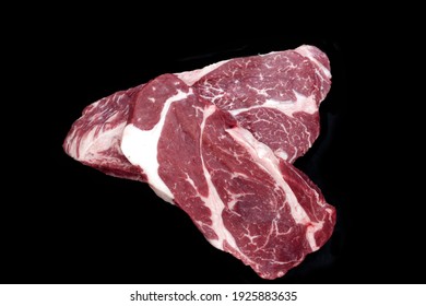 Two Sirloin Beef Steak, Overhead View. Single Raw Striploin Steak From Marbled Beef Isolated On Black Background. Black Angus Beefsteak Meat. Raw Tenderloin Marble Steak. Uncooked Prime Beef Steak.