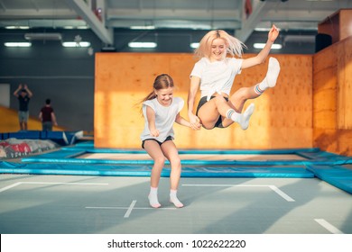 two sisters bouncing in the trampoline park