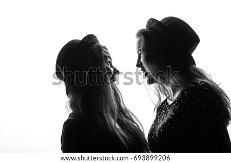 Two sisters in hats, on a white background
