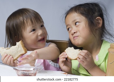 Two Sisters Making A Mess With Peanut Butter And Jelly