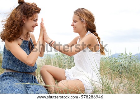 Similar – 2 young women sitting opposite each other