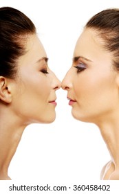 Two sisters standing face to face.