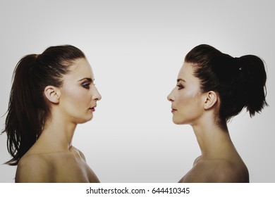 Two sisters standing face to face.