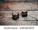 Two six-sided dice on a wooden surface