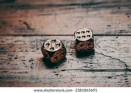 Two six-sided dice on a wooden surface