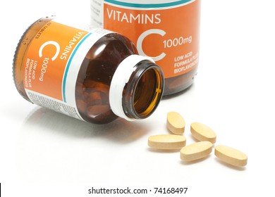 Two Size Of Vitamin C Bottle And Pill With Reflection