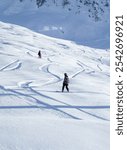 Two skiers on the slope. A snowy winter day. Mountain view.