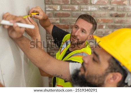 Two skilled construction professionals in safety gear collaborate efficiently on a house remodeling project, demonstrating teamwork, expertise, and commitment to quality workmanship