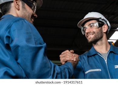 Two skillful factory engineer or worker showing teamwork and partnership . Industrial people and manufacturing labor concept . - Powered by Shutterstock