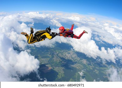 Two skydivers are flying in the sky.