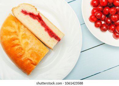 Two slice pie with cherry jam. Homemade dessert. Fresh berries for pastry.