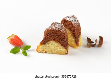 Two Slices Of Marble Bundt Cake On White Background