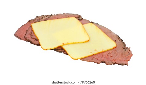 Two Slices Of Muenster Cheese On Top Of Sliced Roast Beef For Sandwiches On A White Background.