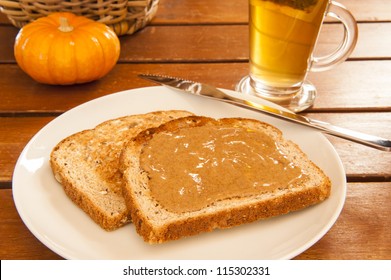 Two Slices Of Multigrain Toast With Almond Butter And Tea