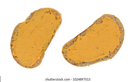 Two Slices Of Wheat Bread With Cheddar Cheese Spread Isolated On A White Background