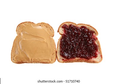 two slices of whole wheat bread with peanut butter and raspberry jelly isolated on white