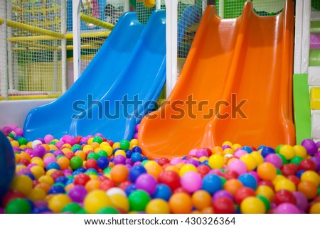 Two slide with colourful balls in the kid's playground.