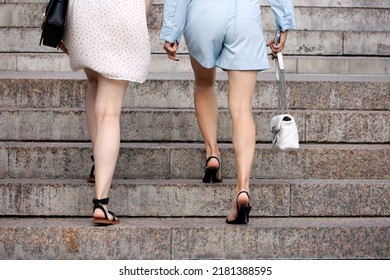 Two Slim Women Going Up The Stairs. Ladies Fashion And Footwear In Summer City