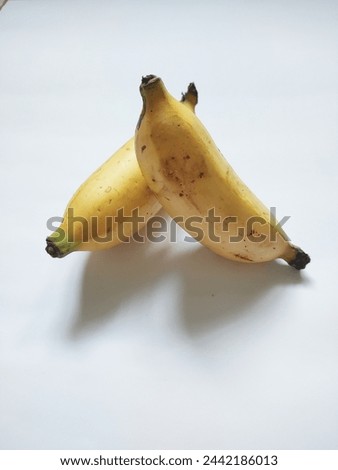 two small bananas from Asia on a white background