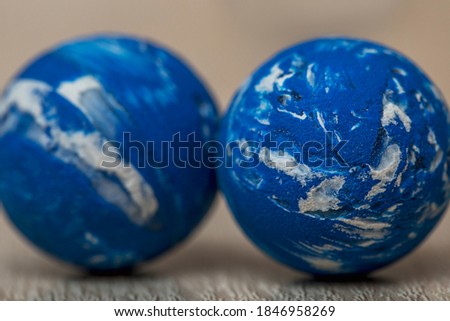 Two small blue rubber balls, similar to the planet Earth, close-up. Toys for children.