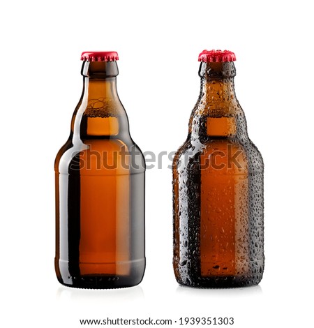 Two small brown beer bottles with and without drops