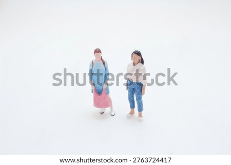 Two small figures pause together in quiet minimal scene