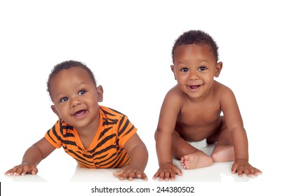 Two small identical black infants on white floor isolated