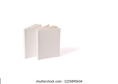 Two Small White Paperbacks Stand On A White Surface On The Left. Can Be Used For Mock-ups. Back Of A Books. Book Cover. Standing Opened Mockup Book. Side View.