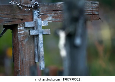 Two Small Wooden Crosses Hanging On The Larger Cross