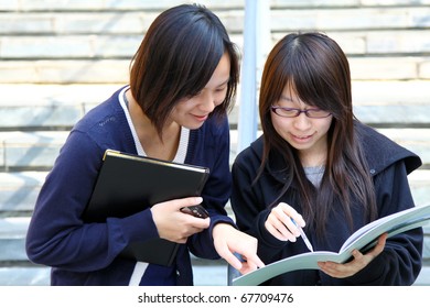 Two Smart Chinese University Students Discussing On Campus