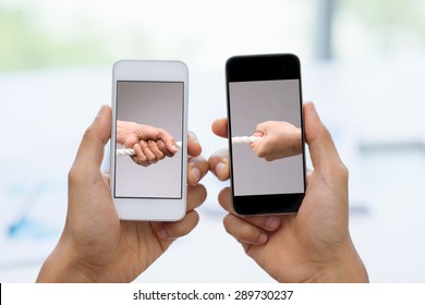 Two Smartphones With Male Hands Pulling Tug Of War