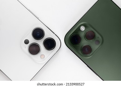 two smartphones on a white background Alpine Green. 
iphone 13 pro max alpine Green  - Shutterstock ID 2133900527