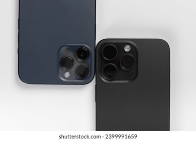 two smartphones on a white background 
iphone 15 pro max black 