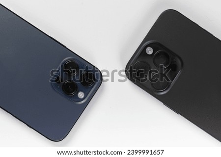 two smartphones on a white background 
iphone 15 pro max black 