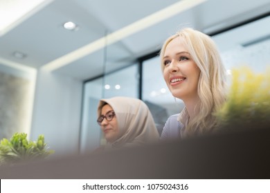 Two Smiley Businesswoman Working Tohether In Office. Healthy Working Enviroment