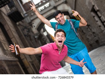 two smiling active male fans who are walking with beer in Barcelona. - Shutterstock ID 726843379