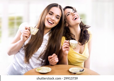 Two smiling girls have coffee time - Powered by Shutterstock