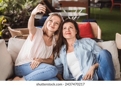 Two smiling girls are photographed together for social media accounts - Powered by Shutterstock