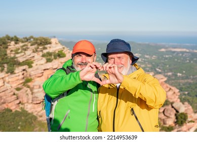 Two Smiling Hiker Friends Making A Heart Shape With Hands - Healthy Lifestyle, Self Love And Active Retirement Concept