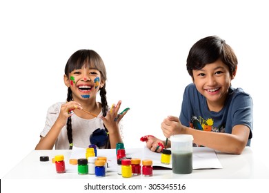 Two Smiling Little Kids At The Table Draw With Water Color, Isolated Over White