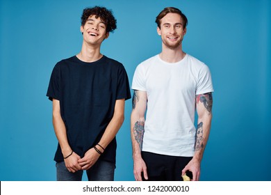 two smiling men in different t-shirts                        