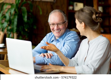 Two Smiling People Discussing Issues In Cafe