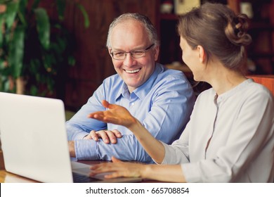 Two Smiling People Discussing Issues In Cafe