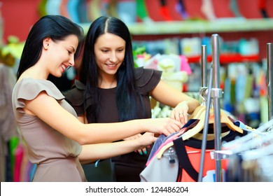 Two Smiling Woman Shopping In Retail Store