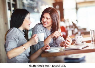 Two Smiling Women Have Coffee Time 